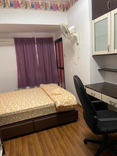 a bedroom with a bed and a desk and a chair at Villa Prisha in Bayan Lepas