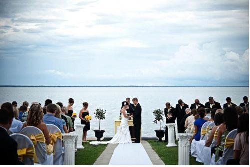 a bride and groom walking down the aisle at their wedding at Lakeside Resort & Conference Center in Houghton Lake
