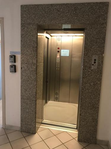 an elevator in a building with a glass door at Krasas Beach in Larnaka
