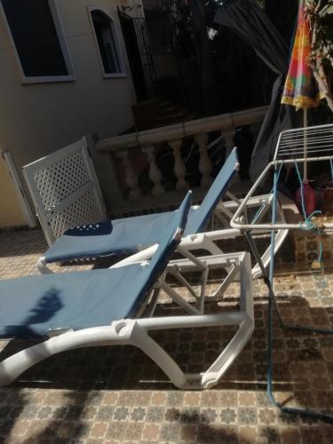 a blue and white lounge chair on a patio at Draga, Agadir appart et piscine dans villa, in Cite Adrar