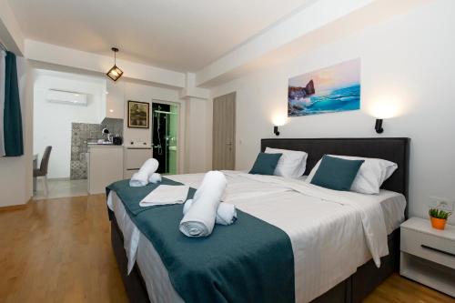 a bedroom with a large bed with white and blue pillows at Gric Apartments in Ohrid