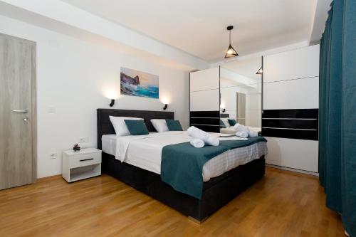 a bedroom with a large bed with blue pillows at Gric Apartments in Ohrid