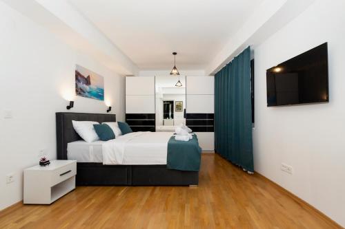 a bedroom with a large bed and a tv at Gric Apartments in Ohrid