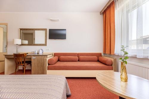 a living room with a couch and a table at Info Hotel in Palanga