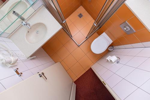 an overhead view of a bathroom with a toilet and shower at Info Hotel in Palanga