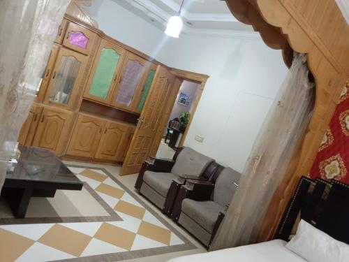 a living room with two chairs and a table at Butt Lodges 3 in Islamabad