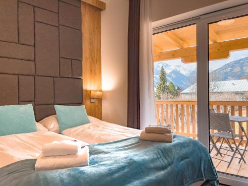 a bedroom with two beds and a balcony at Sylpaulerhof Aparthotel in Sankt Michael im Lungau