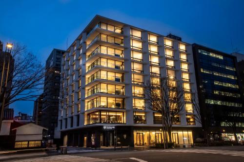 a large building with many windows at night at The Royal Park Hotel Iconic Kyoto in Kyoto