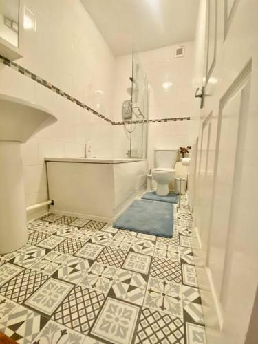 a bathroom with a tub and a toilet in a room at 5 bedroom house near cardiff city. in Cardiff