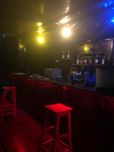 two red stools at a bar in a dark room at Zion INN in Kigali