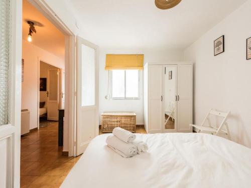 マドリードにあるLa Casa de San Lorenzoの白いベッドルーム(白いベッド1台、椅子付)