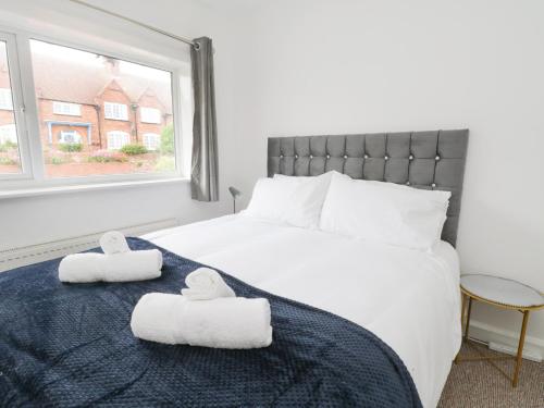 a bedroom with a bed with two towels on it at Butter Cross in Scarborough