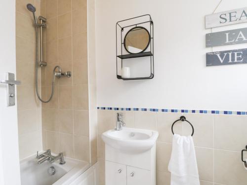 a bathroom with a sink and a toilet and a mirror at Butter Cross in Scarborough