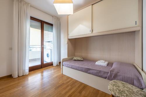 a bedroom with a bed and a large window at Casa Paola in Cagliari