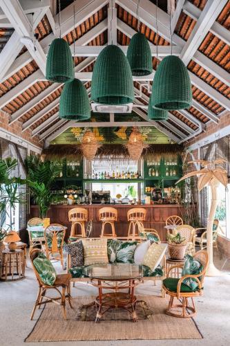 a restaurant with a table and chairs and a bar at The Peri Hotel Hua Hin in Hua Hin