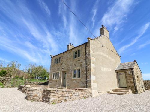 an old stone building on a gravel road at Lanshaw House in Lancaster