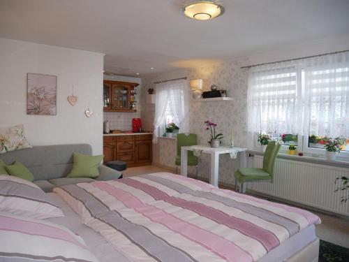 a bedroom with a large bed and a kitchen at Bungalow Rarek "20 Gehmin vom Ostseestrand" in Gothen