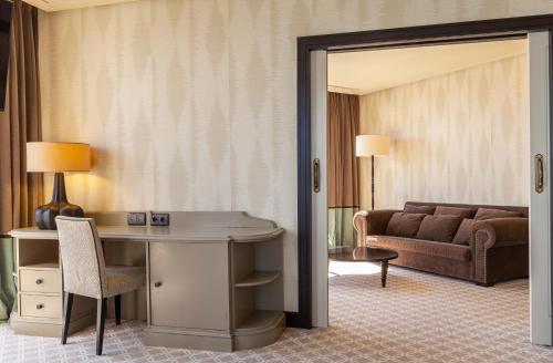 a hotel room with a desk and a couch at Hotel Bahía in Santander