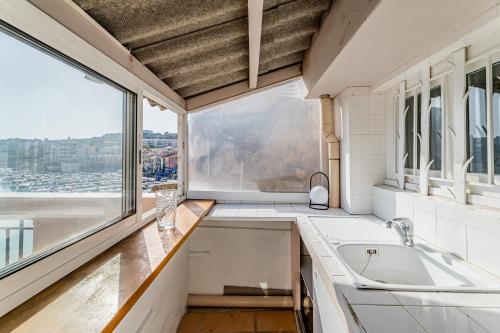 a kitchen with a large window and a sink at Le Rooftop par Dodo-a-Cassis in Cassis