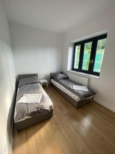 Posteľ alebo postele v izbe v ubytovaní Gdynia Leszczynki