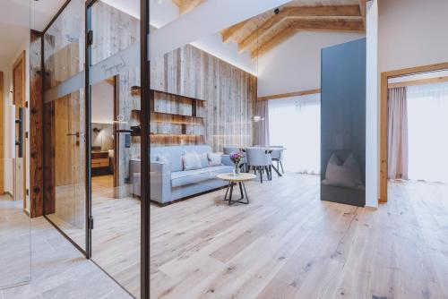 a living room with a couch and a table at ZAGLGUT HOTEL-CHALETS Wellness & Views with Summer Card Included in Kaprun