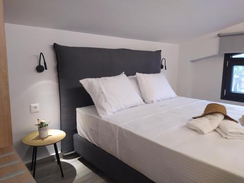 a bedroom with a large bed with white pillows at Flâneur apartments in Ormos Panagias