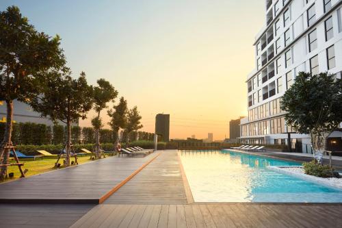 a swimming pool with a view of the ocean at The Quarter Ladprao by UHG in Bangkok