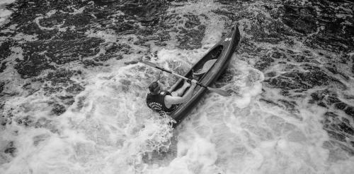 a person is in a kayak in the water at Urzeka in Drzewce