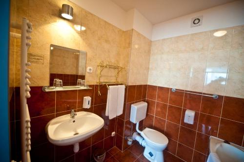 a bathroom with a sink and a toilet at Canada Hotel Budapest in Budapest