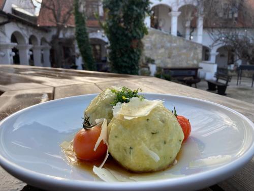 a white plate of food on a table at Oleander Romantik Zimmer in Trausdorf