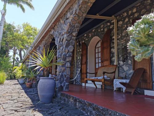 a porch of a house with plants on it at Les Grands Monts in Saint-Joseph