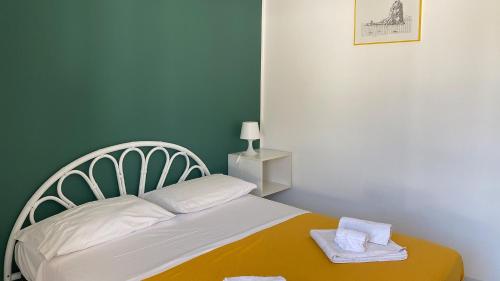 a small bedroom with a bed with towels on it at CannetoMare in Canneto