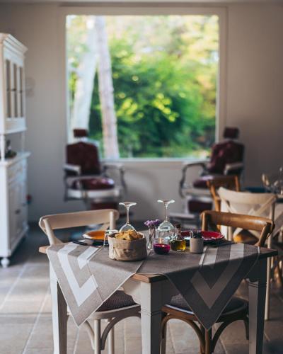 a table with food on it with chairs and a window at Antica Villa Colonica in Sorso