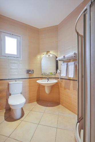 a bathroom with a toilet and a sink at Golden Ocean Marina Hotel in El Alamein