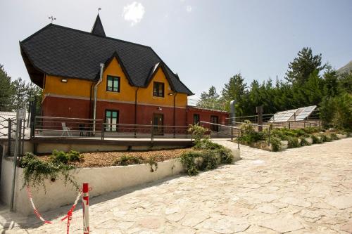 a house with a black roof on top at La Villetta Food & Drink Rooms for Rent - No Reception - in LʼAquila