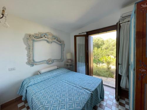 a bedroom with a bed with a mirror on the wall at Villa Smeralda in Olbia