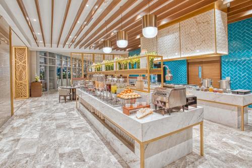 a restaurant with a buffet line with food at Kingsford Hotel Manila Bay in Manila
