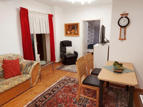a living room with a couch and a table at Ferienwohnung Schlossblick 2 oder 5 in Stainz