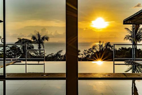 a view of the ocean from a balcony of a resort at Sunset Paradise Villa in Haad Pleayleam