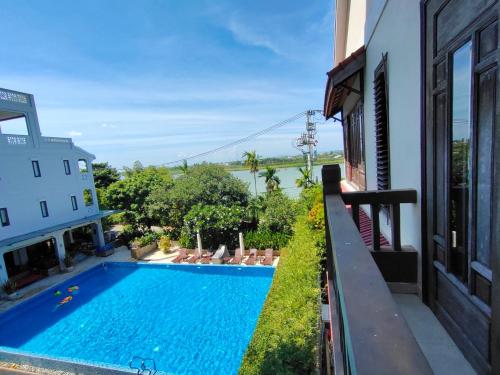 a swimming pool on the side of a building at B'Lan Riverside Villa in Hoi An