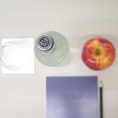an apple and a bottle of eye cream and an apple at Hotel Eden Park by Brava Hoteles in Riudellots de la Selva