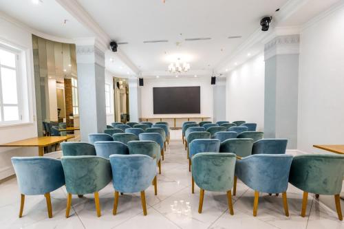 a lecture room with chairs and a screen at Hotel France in Vinnytsya