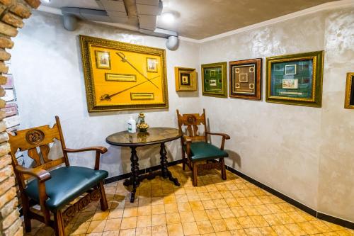 a dining room with a table and two chairs at Hotel France in Vinnytsya