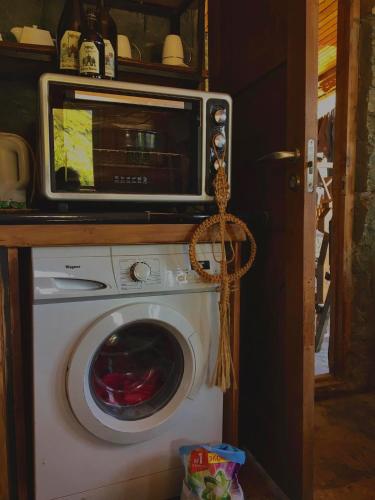a microwave sitting on top of a washing machine at Qaldea Resort in Ushguli