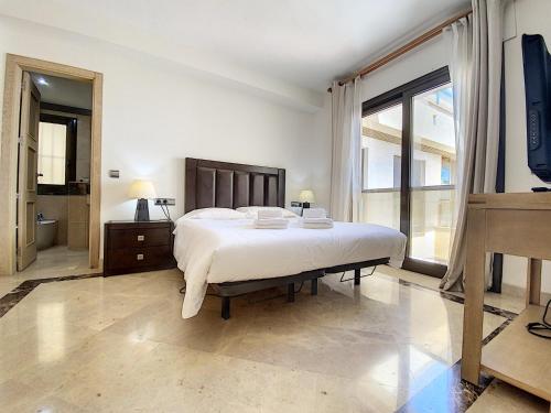 A bed or beds in a room at Lovely apartment with pool & sea views - Marina Del Castillo 2129