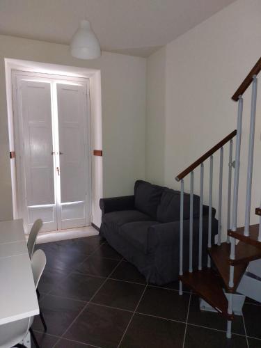 a living room with a couch and a staircase at B&B Anastasia in Buccino