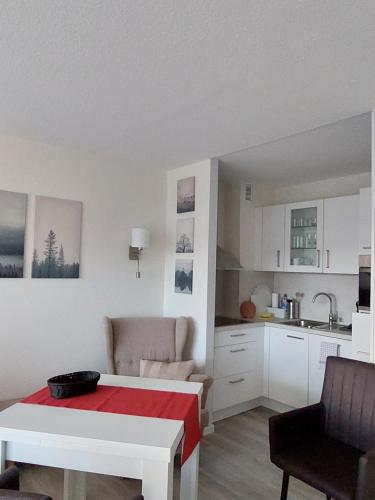a living room with a table and a kitchen at Loreley Lounge II in Patersberg