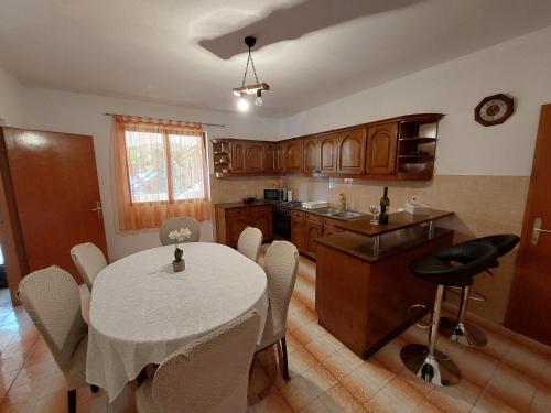 a kitchen with a table and chairs in a room at Apartment Dominik in Smokvica