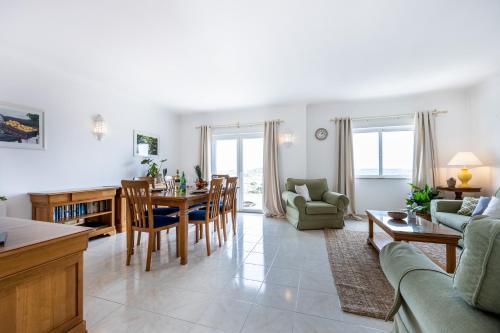 a kitchen and living room with a table and chairs at Townhouse da Amarela in Budens
