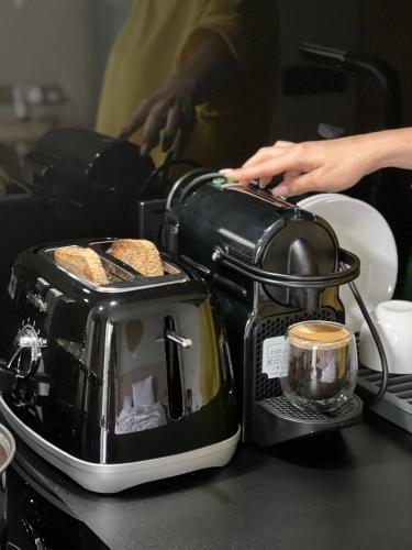 a toaster sitting on top of a counter with bread at SAVOIE Apartments Bukovel in Bukovel
